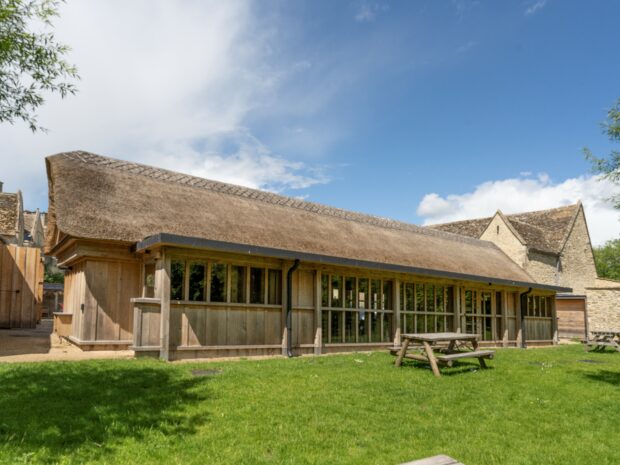 Outside view of Learning Barn at Kelmscott Manor with picnic benches in front