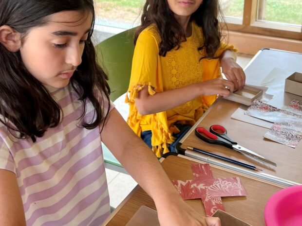 Two children take part in box making workshop
