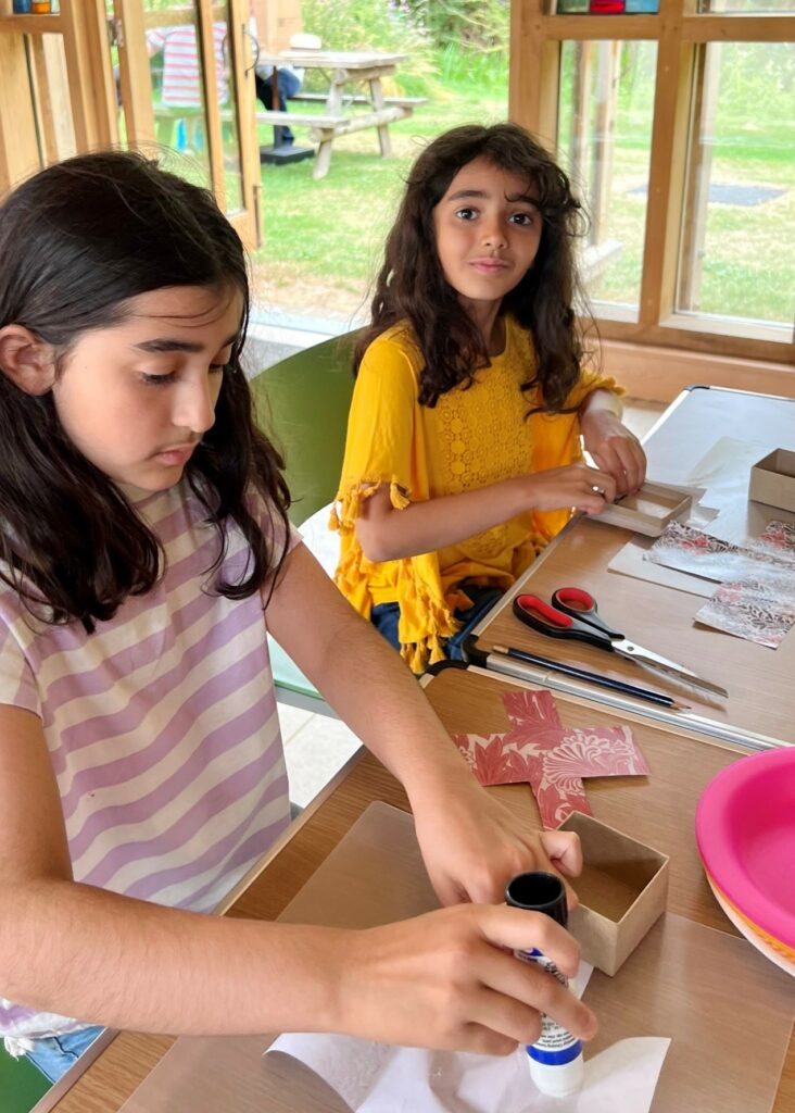 Two children take part in box making workshop