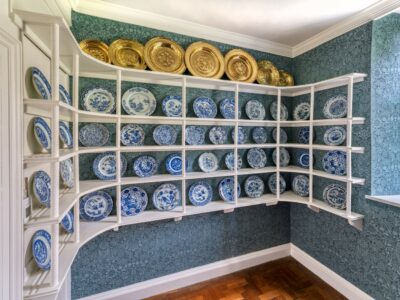 China closet with rows of blue and white china plates