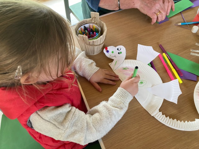 Child decorating a paper dragon