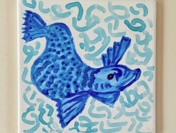 painted tile with fish motif